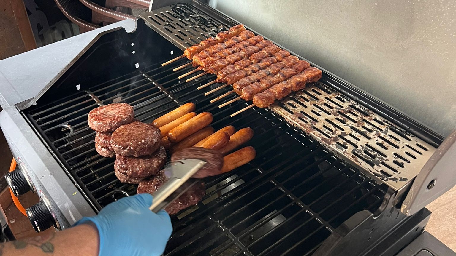 bbq food, burgers and sauages on a grill